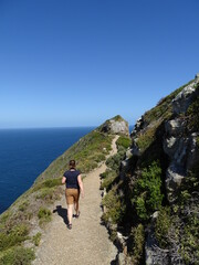 Fototapeta na wymiar cape of good hope in south africa, a woman hiking on a path