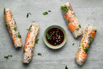 Asian spring rolls set with shrimps, eggs, vegetables and herbs, served with sweet sauce.