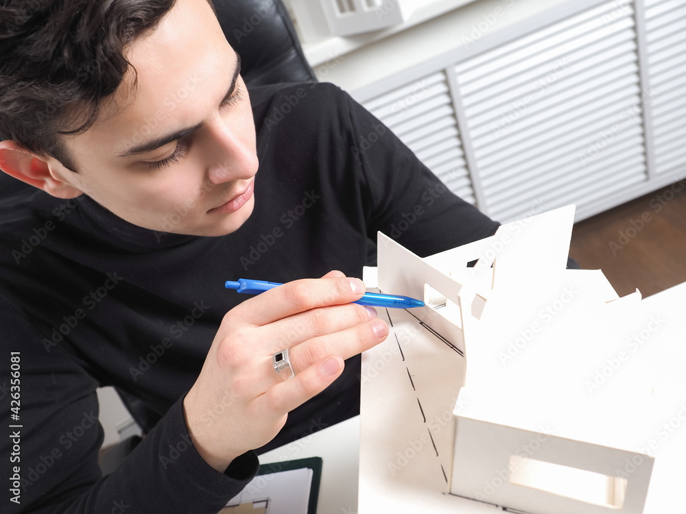 Poster architect is working on the project of the future house. civil engineer examines the layout of the b