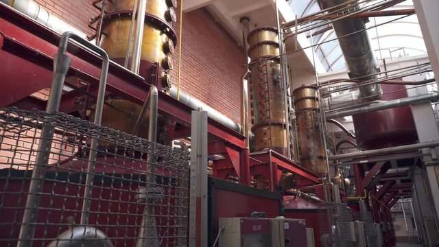 Factory production of brandy. Large tanks of stainless steel and copper. Capacities for fermentation of wine and brandy at the winery. Smooth movement between tanks.
