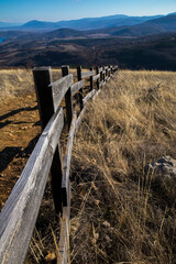Wooden fence on a meadow in the mountains. Background