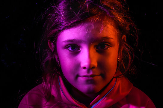 Red Portrait Of Child Girl Isolated On Black Background