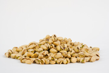  Fresh roasted pistachio nuts isolated on white. Pistachio nuts on white background.  Product for sale.   Copy space.