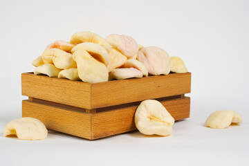  Sun-dried fruits in wooden box isolated on white. Dried apples on white background. Free space for text. Naturally dried white apple.  Product for sale. Studio shot.