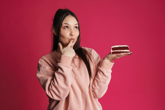 Asian Happy Woman Licking Her Finger While Posing With Cake