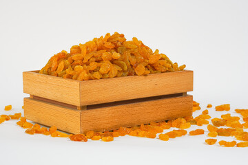 Raisin in wooden box on white background. Dry grapes. Organic dried fruits  isolated on white. Studio light. Free space for text.  Product for sale. 