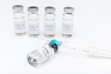 Bottles with coronavirus vaccine, developed for protection against COVID-19. Prevention disease with vaccination injection treatment, syringe