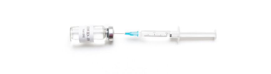 Bottle with coronavirus vaccine with medical syringe close up, developed for protection against...