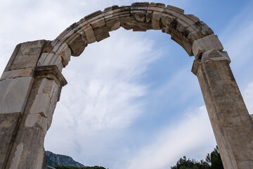 Obraz premium ow angle view of Commercial Agora gate and market square for trade goods and slaves in Ephesus ruins, historical ancient Roman archaeological sites in eastern Mediterranean Ionia region under blue sky