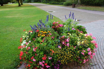 round mixborder with colorful flowers in the park
