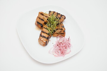 Delicious grilled pork ribs in BBQ sauce with herbs, isolated on white background