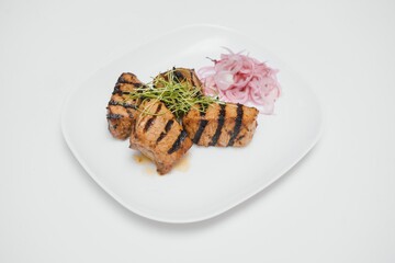 Delicious grilled pork ribs in BBQ sauce with herbs, isolated on white background