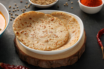Aloo Paratha , parantha  , roti , chapati with melting butter Indian flatbread with potato vegetable stuffing Punjab, Delhi, North India. Indian side dish  pickle, dal, paneer tikka masala