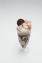 Tasty milk shake with chocolate topping on white background