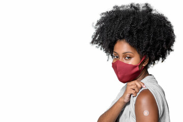 black teenager wearing protective mask against covid-19 with a smile on his face shows the vaccine brand, isolated on white background