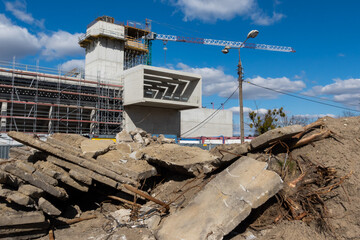 Obraz na płótnie Canvas Construction crane on the construction site of a public facility. Dissorder at the construction site. Photo taken on a sunny day.