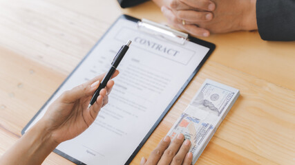 Business people giving a bribe of money at contract, Corruption concept..