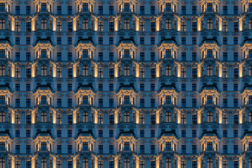 Architectural pattern, old building at night with illuminated stucco