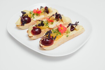 Different kinds of colorful sandwiches on black chalkboard background from above (top view). Party starter or appetizer - flat lay composition.