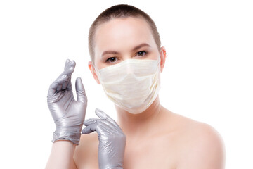 Beauty portrait of a short-haired woman in mask and gloves