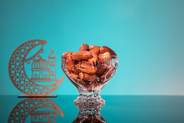 Muslim iftar of breaking of fast during Ramadan month with preserved sweet dates.. Decorative...