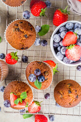 Vanilla muffins or cupcakes with berries