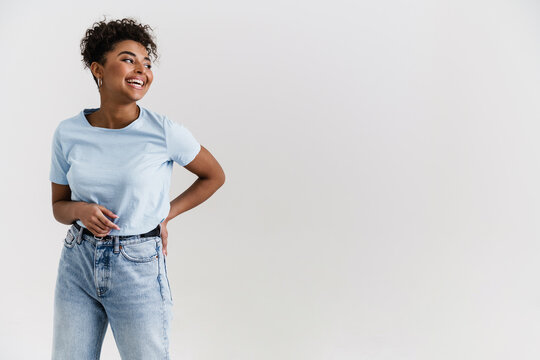 Young black woman in t-shirt laughing and looking aside