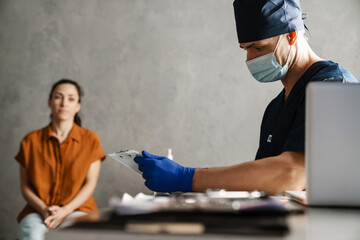 Woman patient and man doctor sitting in the cabinet