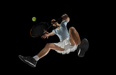 Female professional tennis player in action, motion isolated on black background, look from the...