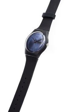 Geneve, Switzerland 07.10.2020 - Swatch cheapest trendy swiss made plastic watch on stand, simple black design, blue dial, Value Price concept. Swatch Group watch production