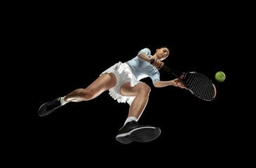 Female professional tennis player in action, motion isolated on black background, look from the...