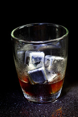 Cold americano decoration with stainless steel cubes ice  on a black table.