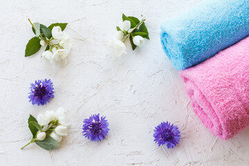 Fototapeta na wymiar Towels and beautiful flowers on a white background.