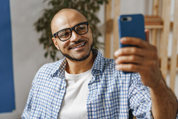 Portrait of a smiling young african american man taking selfie