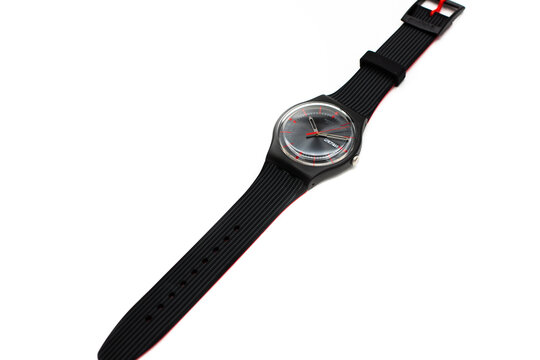 Geneve, Switzerland 07.10.2020 - Swatch cheapest trendy swiss made plastic watch, simple black design, Red seconds arrow, Sunday 15 on calender. Value Price concept.
