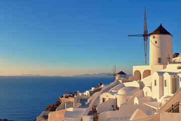 Sunset over Santorini island in Greece. Traditional church, apar