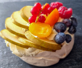 Dessert Mini Pavlova meringue with whipped cream and and mix of fresh fruits.