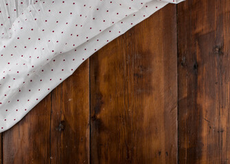 White polka dot tablecloth or towel over the surface of a wooden table - Powered by Adobe