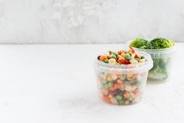 Frozen vegetables in containers. Horizontal orientation, copy space.