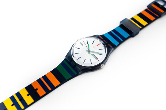 Rome, Italy 07.10.2020 - Swatch children's trendy fashion swiss made quartz watch isolated on white background. plastic case striped design strap, youth hipster style watch for bright image.