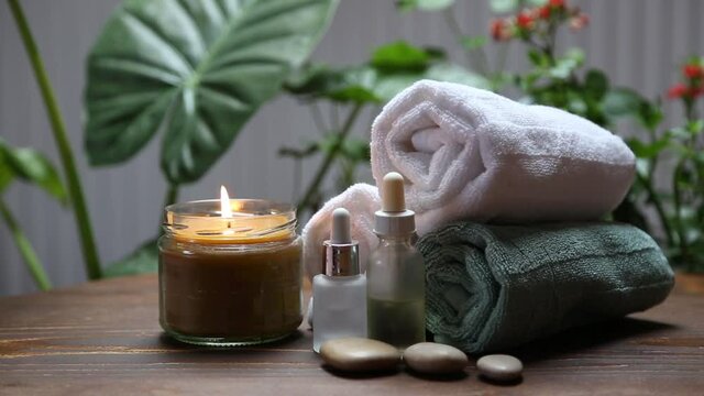 Spa still life with candle, skincare and bath towels, spa and wellness background