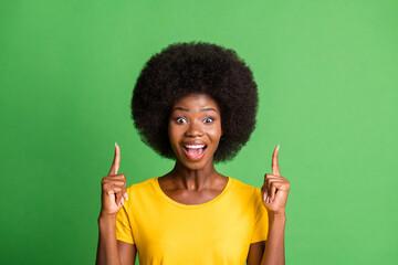 Photo portrait of happy girl recommending pointing fingers up copyspace isolated on vibrant green color background