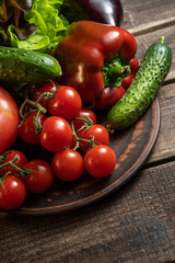 Multiple fresh organic vegetables on a wooden background