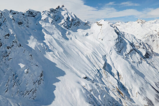 Aerial view of Elbrus and Cheget mountains in snow in winter upon the clouds, climbing and mountain skiing © Elena