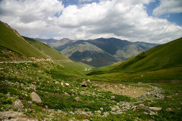 Fototapeta na wymiar Winding Road in the Tian Shan Mountains leading to Song Kol Lake, Kyrgyzstan, Central Asia
