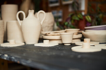 Collection of handmade pottery on table in workshop