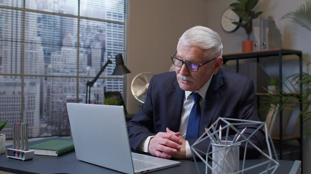 Business man using laptop, internet online meeting conference in office webinar talking on webcam. Senior male professional manager web designer making video call. Coworking, cooperation, chatting
