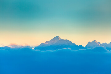 Mountain peaks in the clouds. Evening light. North Caucasus, Kabardino-Balkaria, Russia.