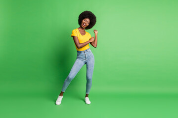 Fototapeta na wymiar Full length photo of charming funky afro american lady dance good mood isolated on green color background