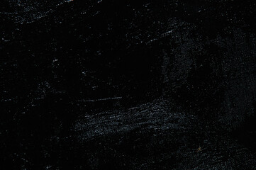 Dark creative background - rough linen canvas unevenly covered with black primer, reflections of light. Toning, blurring, selective focus.